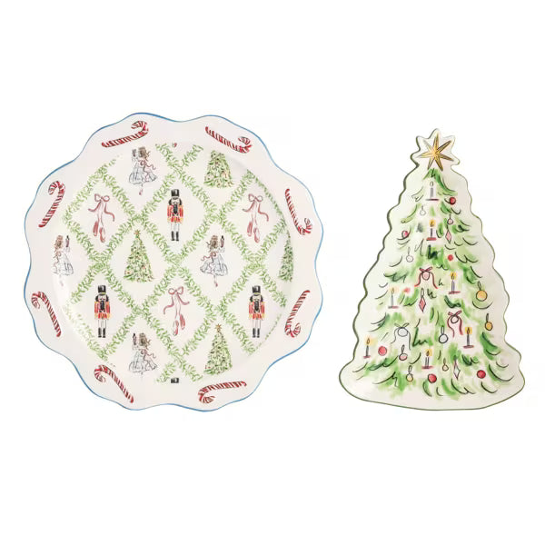 A holiday-themed ceramic dinnerware set featuring a scalloped plate and a Christmas tree-shaped dish, both decorated with green lattice patterns, nutcracker figures, candy canes, and ornaments on a white background.