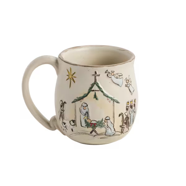 A ceramic mug with a hand-painted nativity scene on a warm cream background, featuring a stable, star, angels, and wise men.