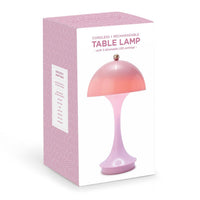 Pink table lamp with packaging on a white background