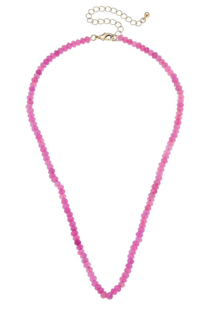 Pink beaded necklace on a white background