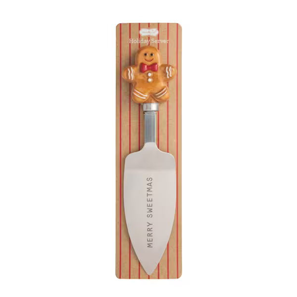 A Christmas-themed serving spatula with a gingerbread man handle, mounted on a striped wooden display card that reads 'Holiday Shaver' and 'MERRY SWEETHAS'.