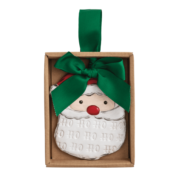 A Santa Claus Christmas ornament in a brown gift box with a green ribbon bow and hanging loop, shown on a plain white background.