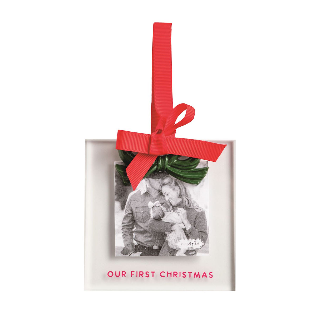 A personalized Christmas ornament in a square white frame with a red hanging ribbon and bow, featuring a black-and-white photo of a couple and the text 'OUR FIRST CHRISTMAS' in red at the bottom.