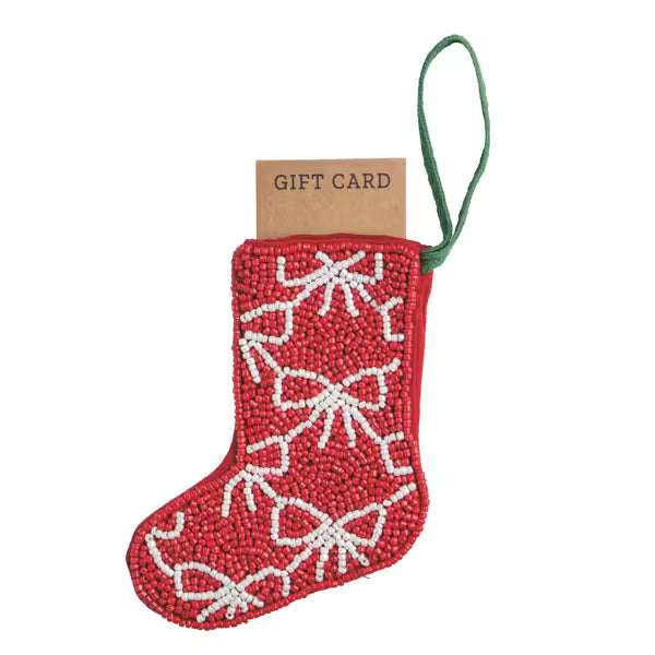 Red beaded stocking with white bows and a gift card on a white background