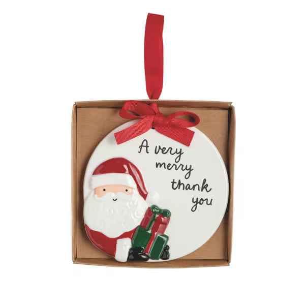 A round white ceramic Christmas ornament featuring a 3D Santa Claus figure and the text 'A very merry thank you', presented inside a brown gift box with a red ribbon loop.