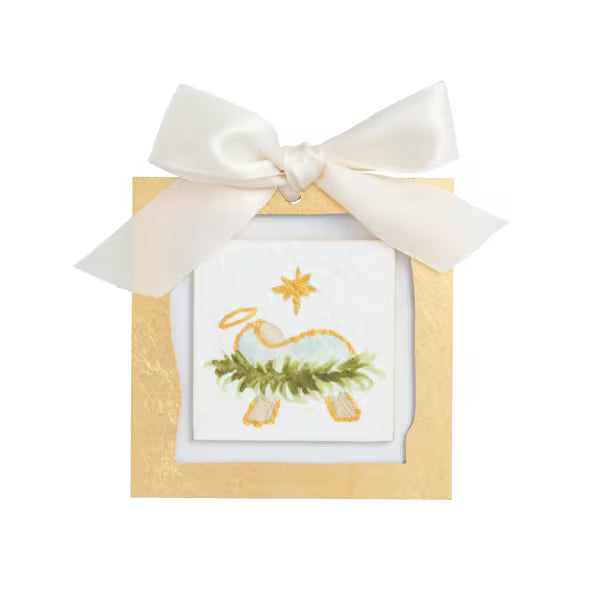 A square gift box with a white satin bow on top, featuring a small embroidered or printed illustration of a white deer with a green wreath and gold star on the front.