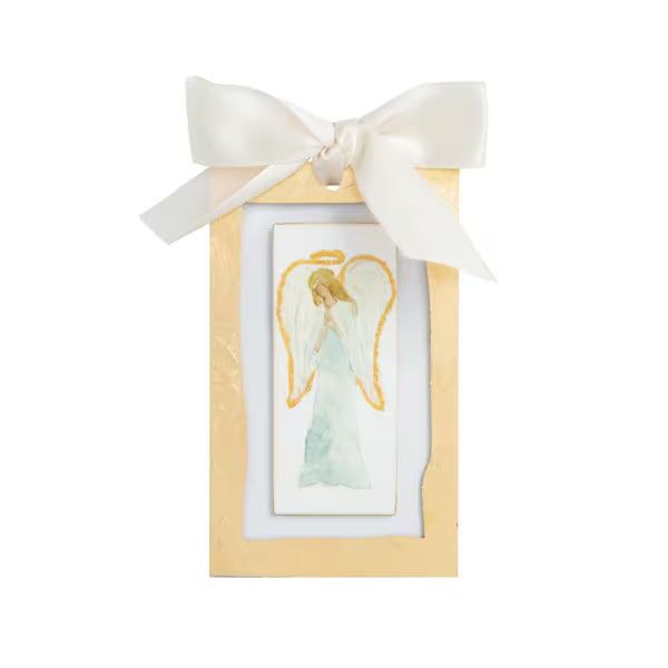 Small framed angel artwork ornamentwith a white bow on a white background