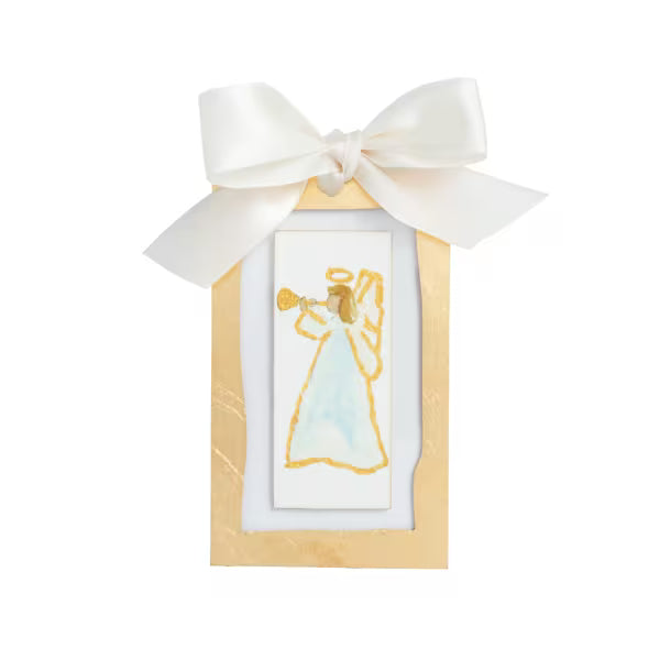 A small gold-framed art print featuring a gold-leaf painted angel playing a trumpet, adorned with a large white satin bow at the top, set against a plain white background.