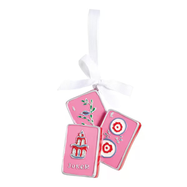 Pink playing card charms with decorative designs on a white background