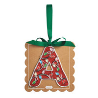 A scalloped brown kraft paper ornament featuring a large embroidered letter 'A' filled with a red holiday lights pattern, tied with a green ribbon and hanging loop against a white background.