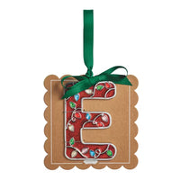 A decorative hanging ornament shaped like the letter E, made from kraft paper with a red holiday lights pattern and colorful jewel accents, tied with a green ribbon on a white background.