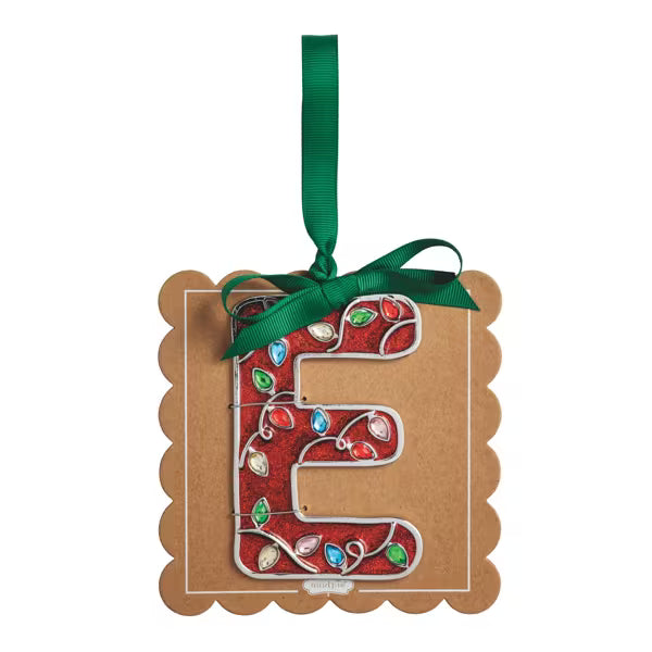 A decorative hanging ornament shaped like the letter E, made from kraft paper with a red holiday lights pattern and colorful jewel accents, tied with a green ribbon on a white background.