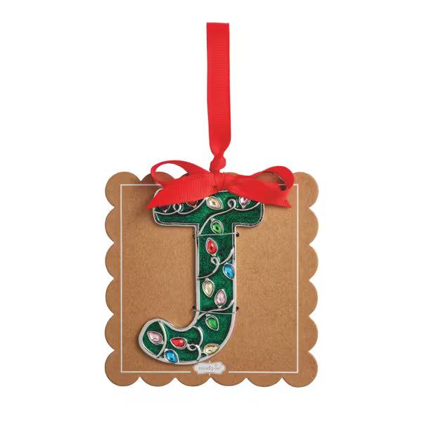 A decorative hanging ornament shaped like the letter J, decorated with green holiday lights and a red ribbon bow, attached to a brown kraft paper backing card on a white background.