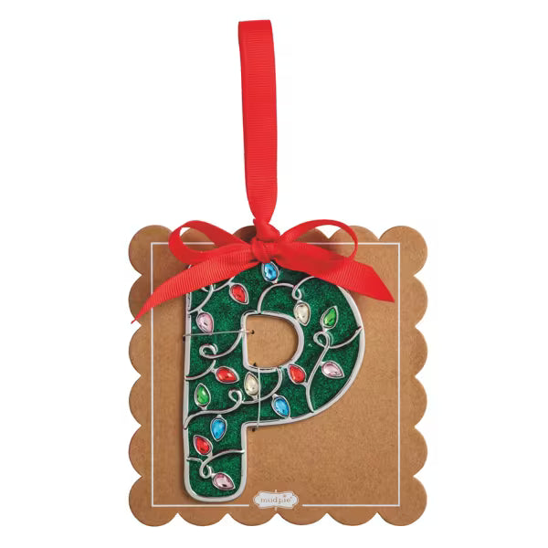 A decorative hanging ornament shaped like the letter P, mounted on a kraft paper backing card. The letter is filled with glittery green and decorated with colorful faceted rhinestones connected by silver wire in a holiday light pattern.