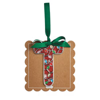 A decorative hanging ornament shaped like the letter T, made from a brown kraft cardstock base with a red and green mosaic pattern in the center, finished with a green ribbon loop at the top.