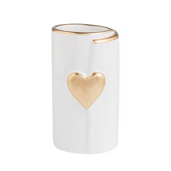 A white cylindrical ceramic candle holder with a metallic gold heart on the front and a gold-trimmed rim, shown on a plain white background.