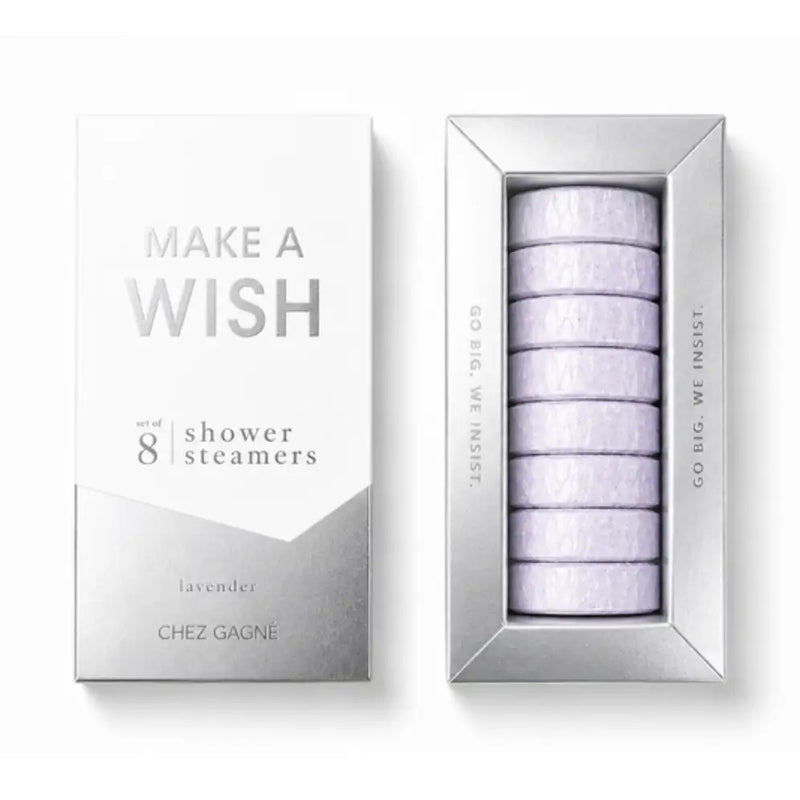 Chez Gagné 'Make A Wish' lavender shower steamers, showing the silver and white outer packaging box next to the silver tray containing eight round lavender steamers.