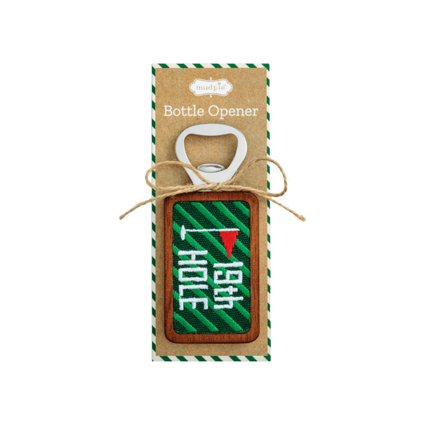 A bottle opener gift set on a kraft paper backing card. The opener features a green and white striped wooden plaque with white Japanese characters and a small red flag, tied with a twine bow.