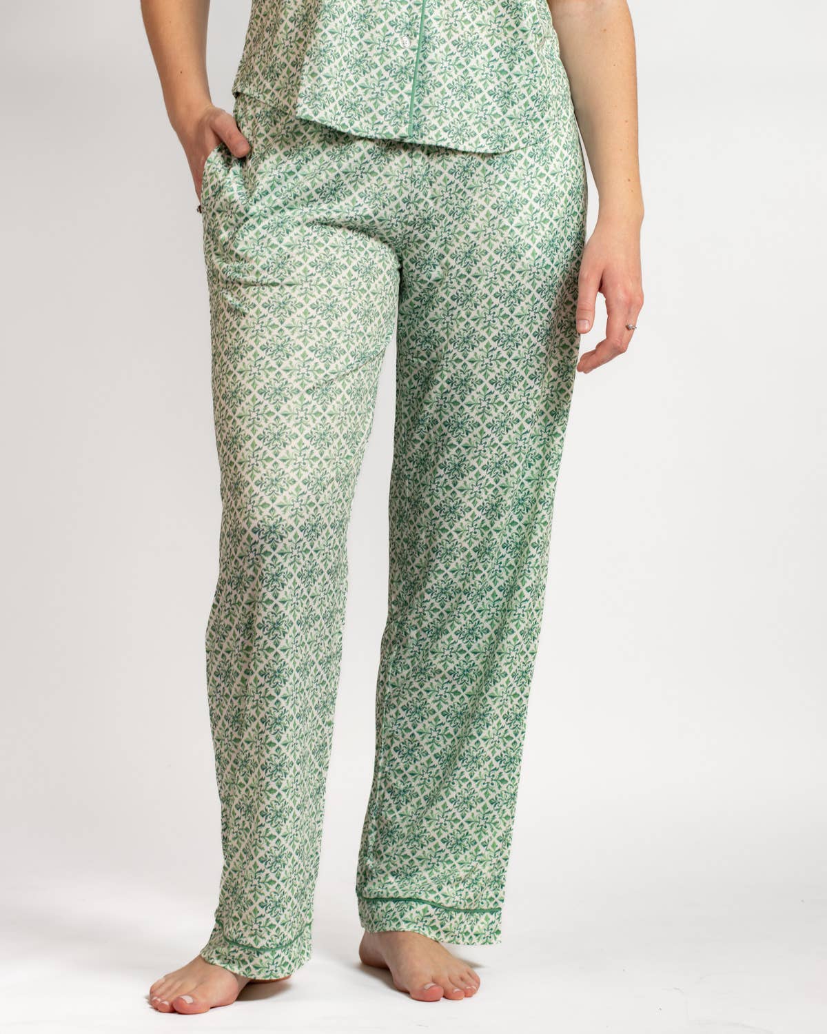 Green patterned pajama set worn by a person on a white background