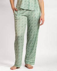 Green patterned pajama set worn by a person on a white background