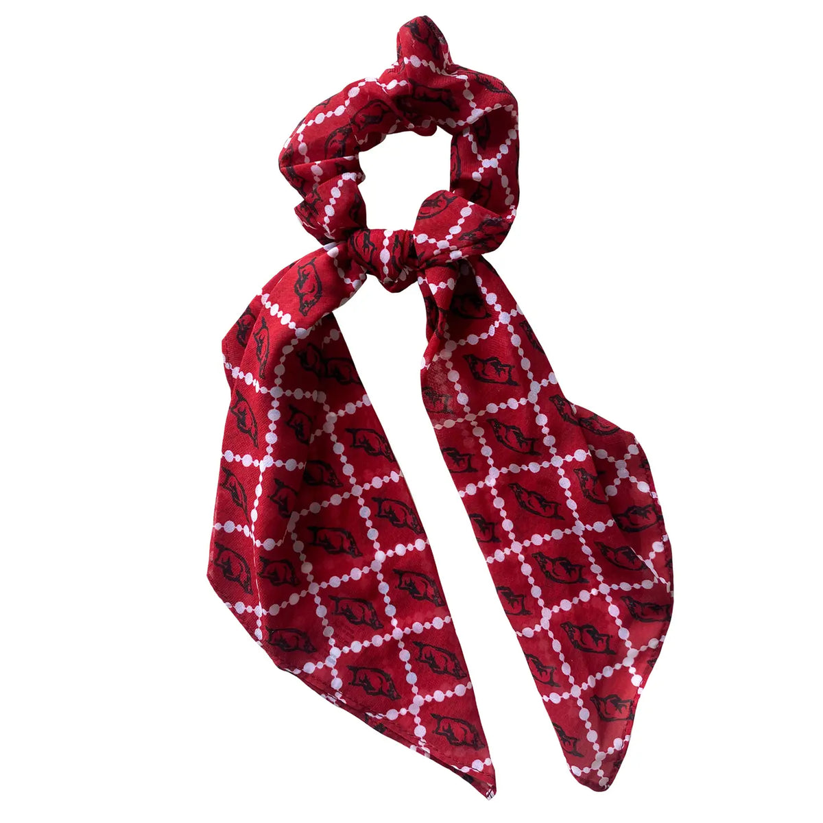 A red fabric hair scrunchie with a tied bow, featuring a white dotted diamond lattice pattern with black elephant silhouettes, set against a plain white background.