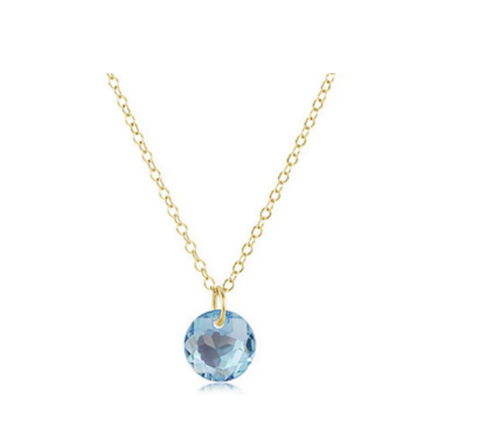 Gold necklace with a floral pendant on a white background