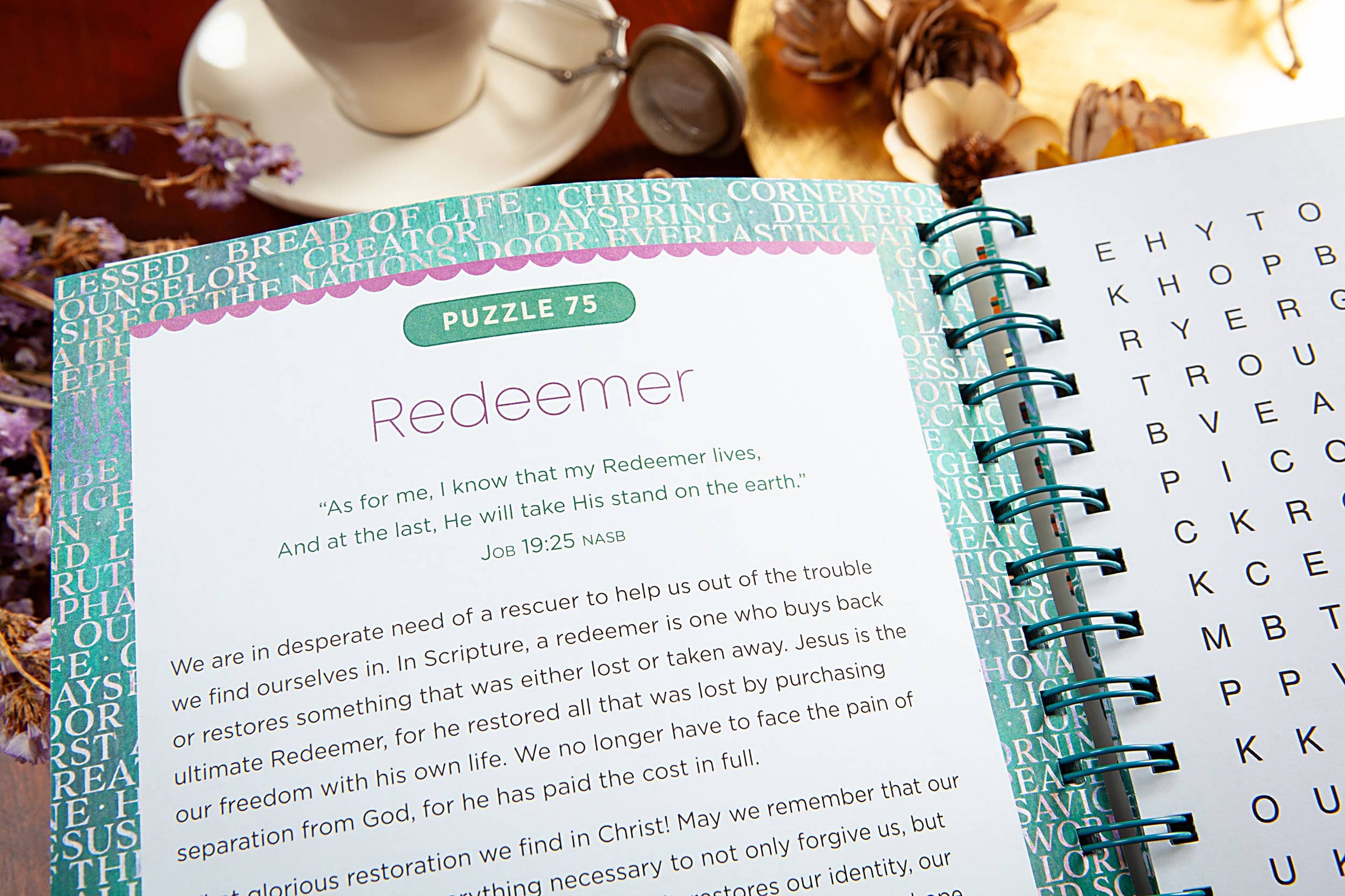 Open book with a puzzle titled 'Redeemer' on a table with a cup and saucer.