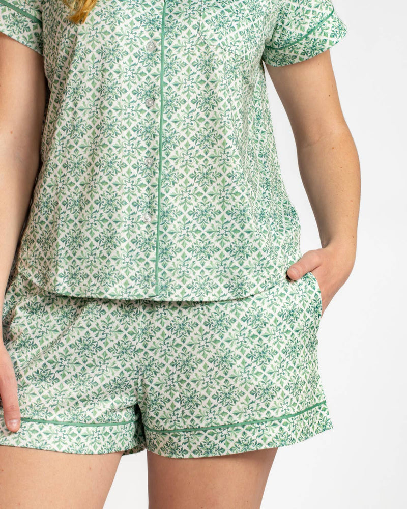 Green patterned pajama set worn by a person on a white background