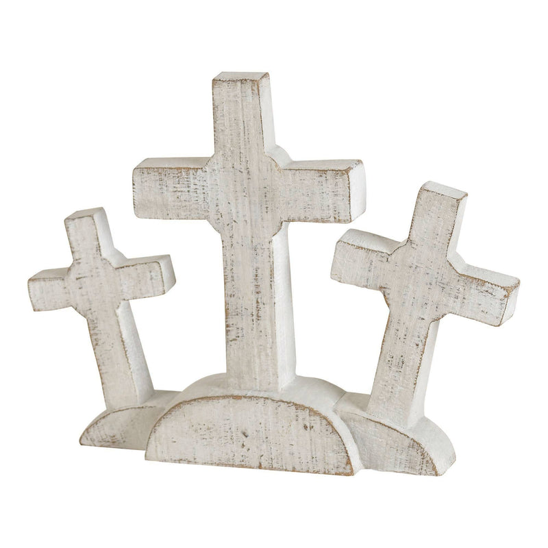 Set of three white wooden crosses on a white background