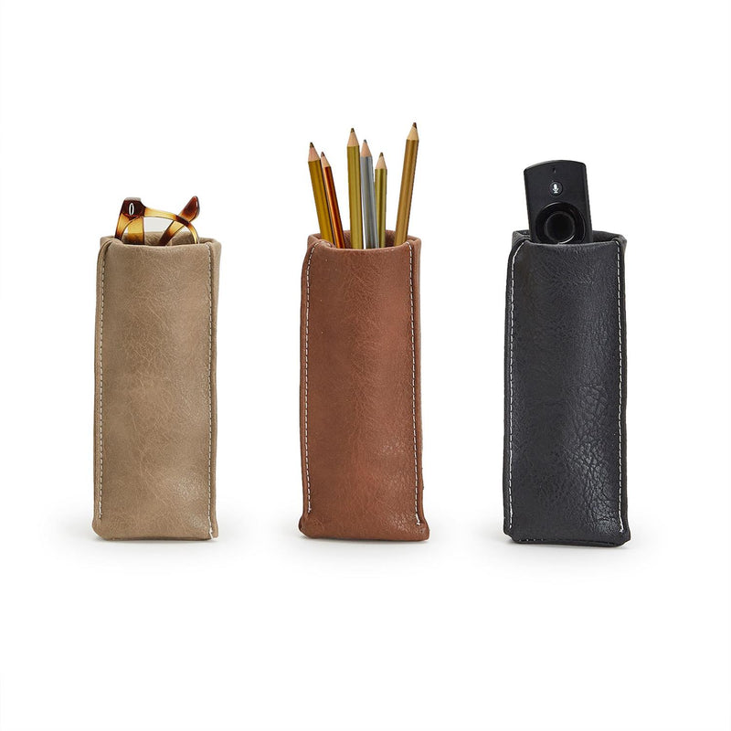 Three leather pouches in beige, brown, and black with various items inside on a white background.