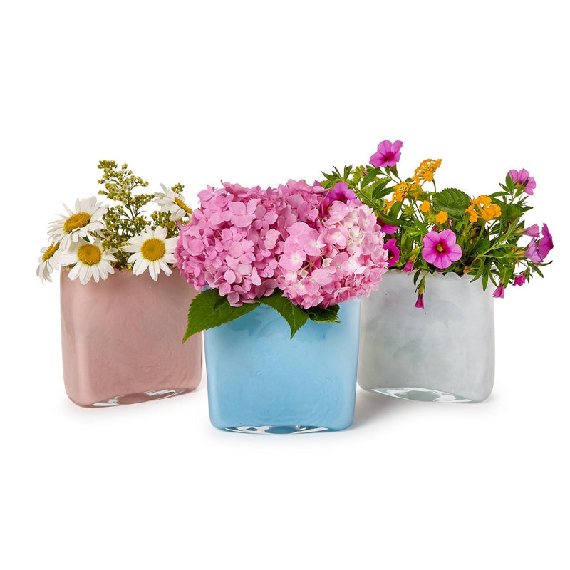 Three colorful vases with flowers on a white background