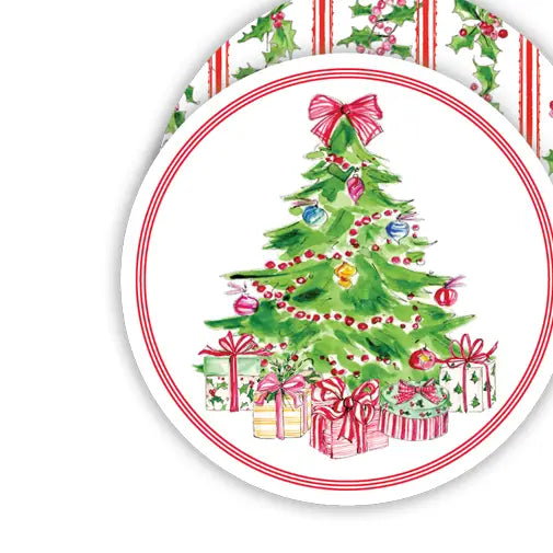 A round white coaster featuring a watercolor Christmas tree with ornaments, presents, and a red bow, with a striped holly and berry pattern visible along the top edge.