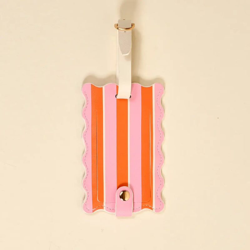 Striped luggage tag with pink and orange design on a beige background