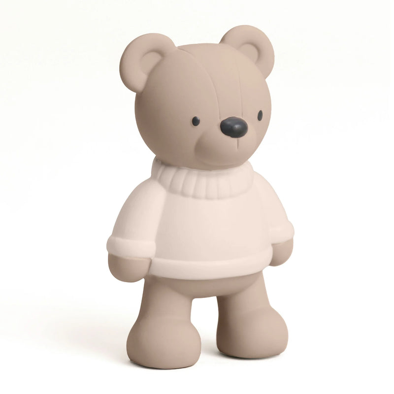 Teddy bear teether toy on a beige background.