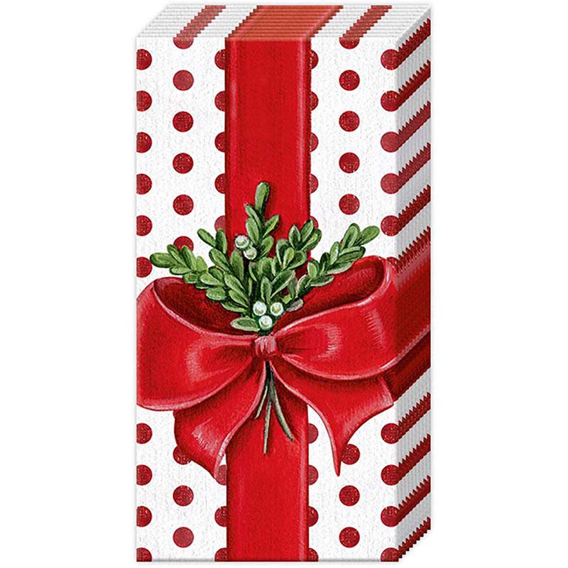 Tissues printed with as a rectangular gift box wrapped in festive red and white patterned paper, tied with a large red ribbon and bow, and decorated with green holly leaves and berries, shown on a plain white background.