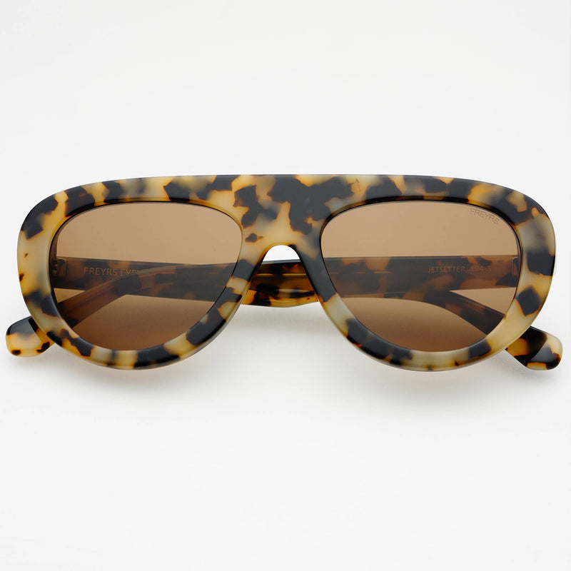 Sunglasses with tortoiseshell frame and brown lenses on a white background