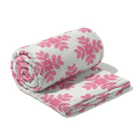 Roll of pink floral-patterned fabric on a white background