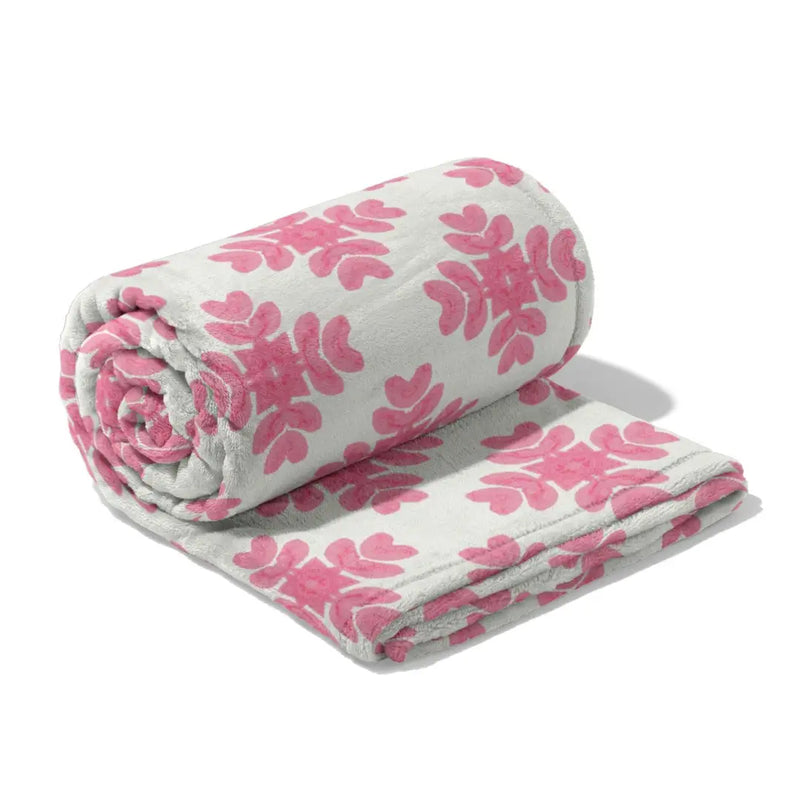 Roll of pink floral-patterned fabric on a white background