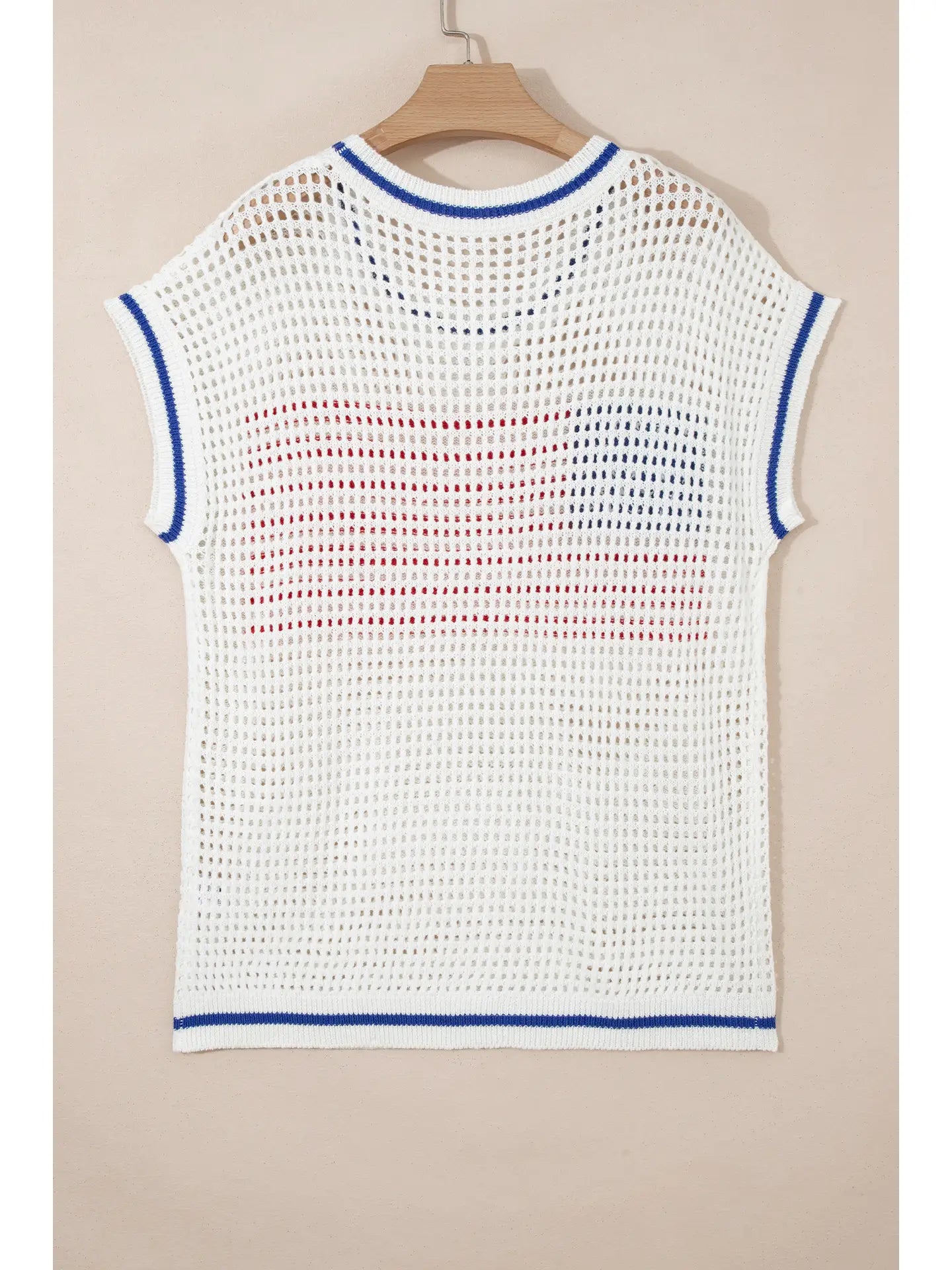 White crochet top with blue and red accents on a beige background