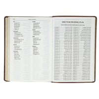 Open book with a one-year reading plan on a white background