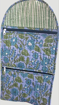 Floral-patterned bag with a striped interior on a light gray background