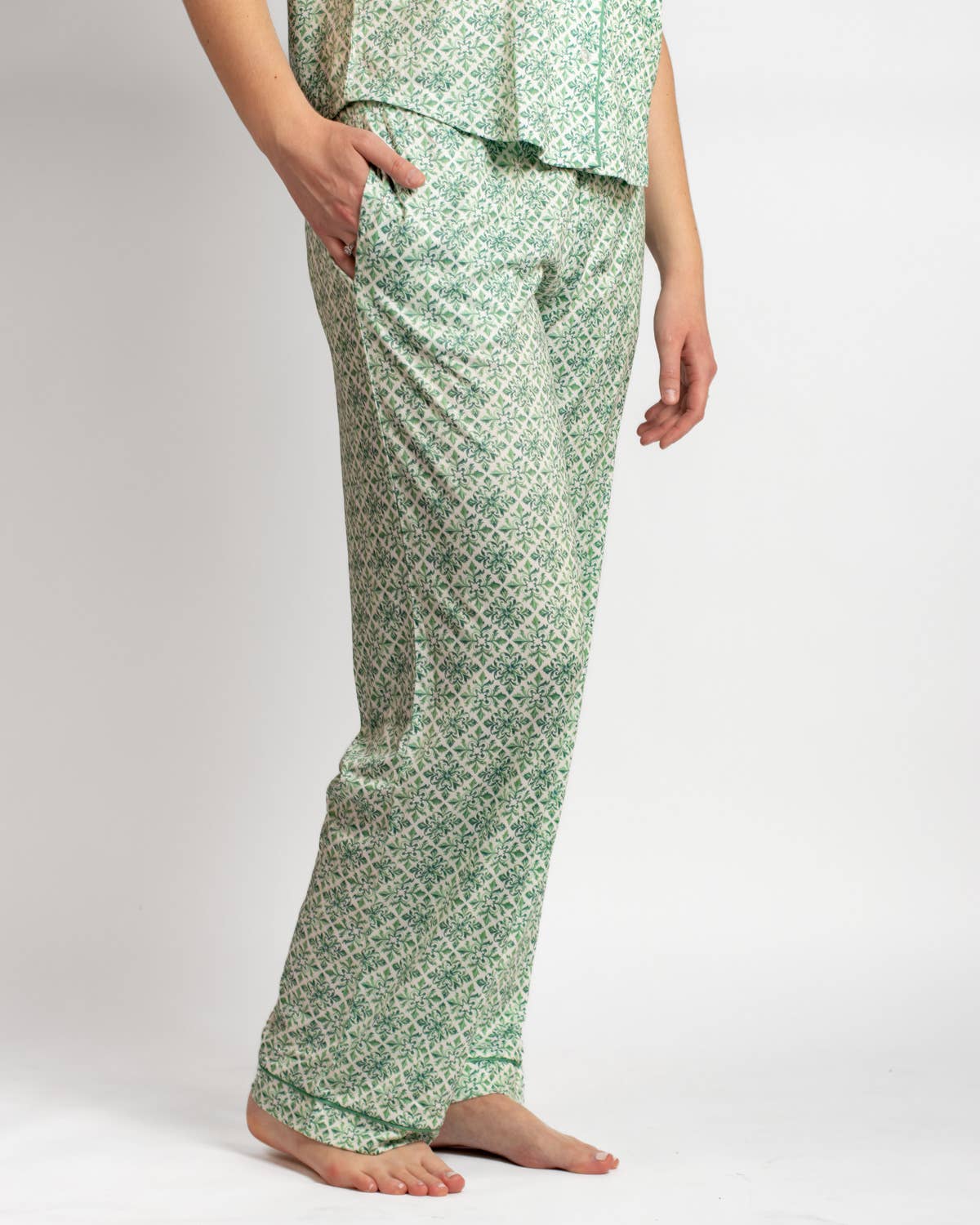 Green patterned pajama set worn by a person on a white background