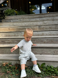 Child wearing Blue Stripe Short Sleeved Outfit
