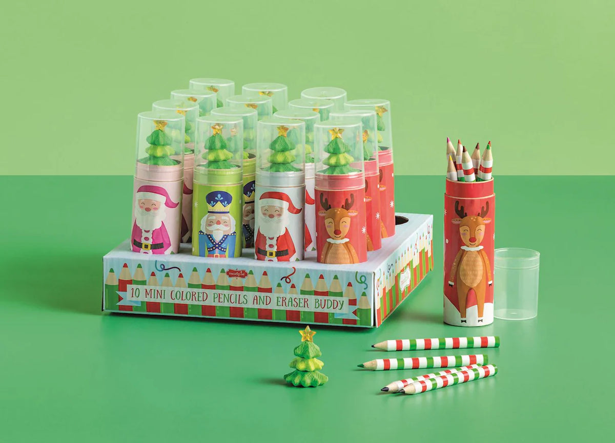 Set of mini colored pencils and eraser buddy with Christmas-themed packaging on a green background
