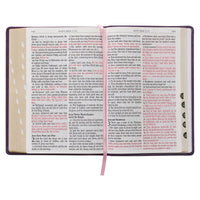 Open book with text and a pink ribbon marker on a white background