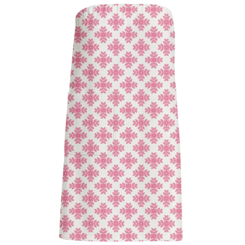 Pink floral patterned bath wrap towel on a white background