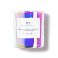 Candle with a colorful label and 'MOODCAST' branding on a white background