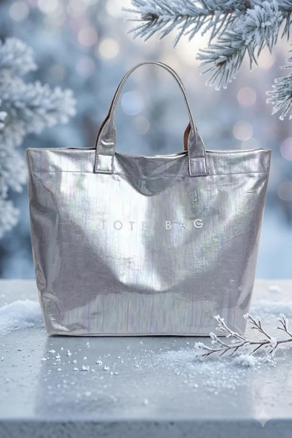 Silver tote bag on a snowy surface with blurred winter background