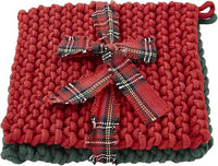 A square red knit potholder with a dark green border and a red tartan plaid ribbon tied in a bow across the center, shown on a white background.