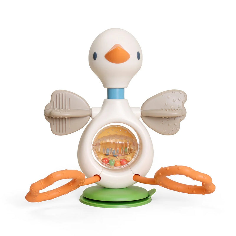 Duck-shaped sensory toy with orange rings and textured panels on a light beige background. 